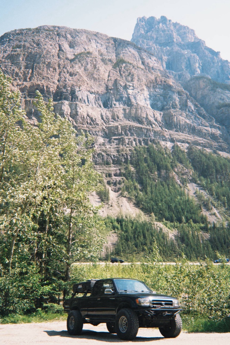 Finn's Tacoma under a cliff face in Banff